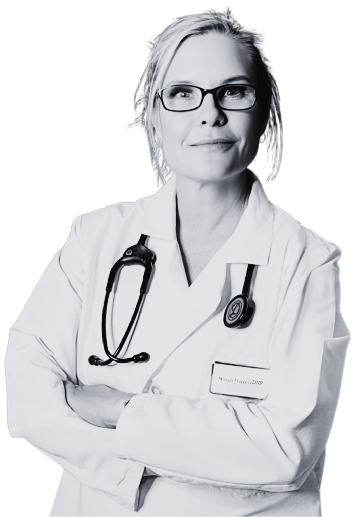 Dr. Wendi Harper, DNP, wearing a white lab coat and stethoscope, medical aesthetics injector and clinical trainer at Heddy