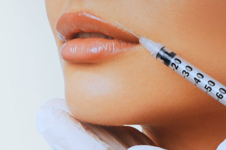 Close-up of a syringe performing a facial injectable treatment along the jawline and chin, representing the growing mainstream adoption of aesthetic injectables and expanding demand across broader patient populations.