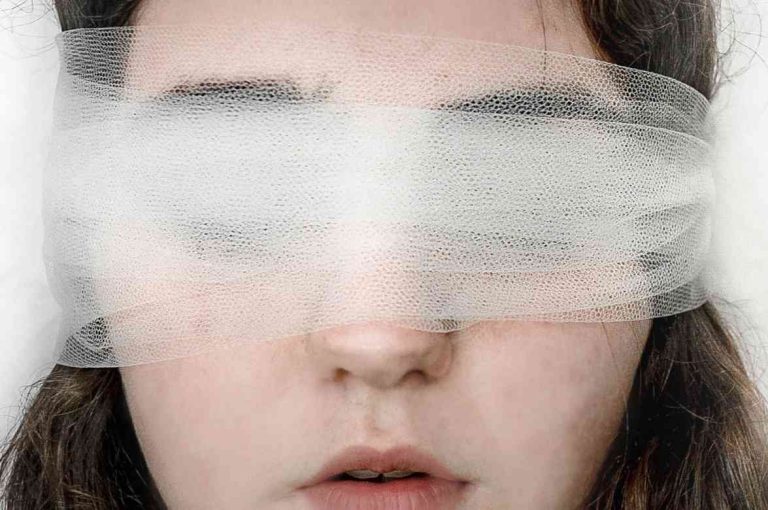 Face obscured by gauze representing gaps in global pharmacovigilance of aesthetic botulinum toxin adverse event reporting